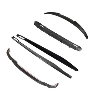 Set of black carbon-fiber car body parts (front lip, side skirts, rear spoiler blades, and a wiper blade) laid out for assembly or replacement