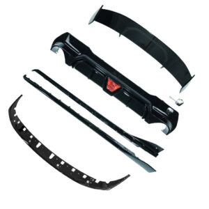 Disassembled black car bumper kit with front bumper, side lips, and supporting strips laid out separately.