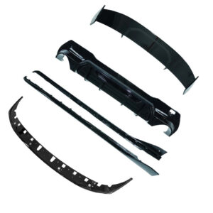 Disassembled black car bumper parts laid out: bumper cover, reinforcement beam, side rails and mounting brackets.