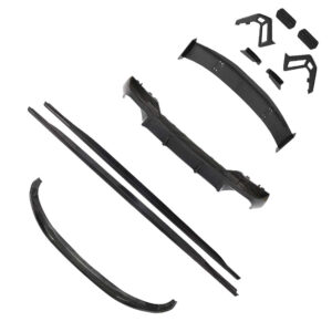 Set of black automotive body parts laid out: curved front lip, long side skirts, rocker panels, and small mounting brackets (carbon-fiber look).