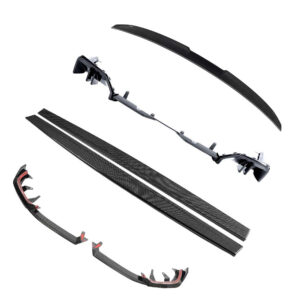 Set of carbon fiber automotive aero parts, including a long curved rear wing, side fins, and bumper pieces laid out separately on a white background.