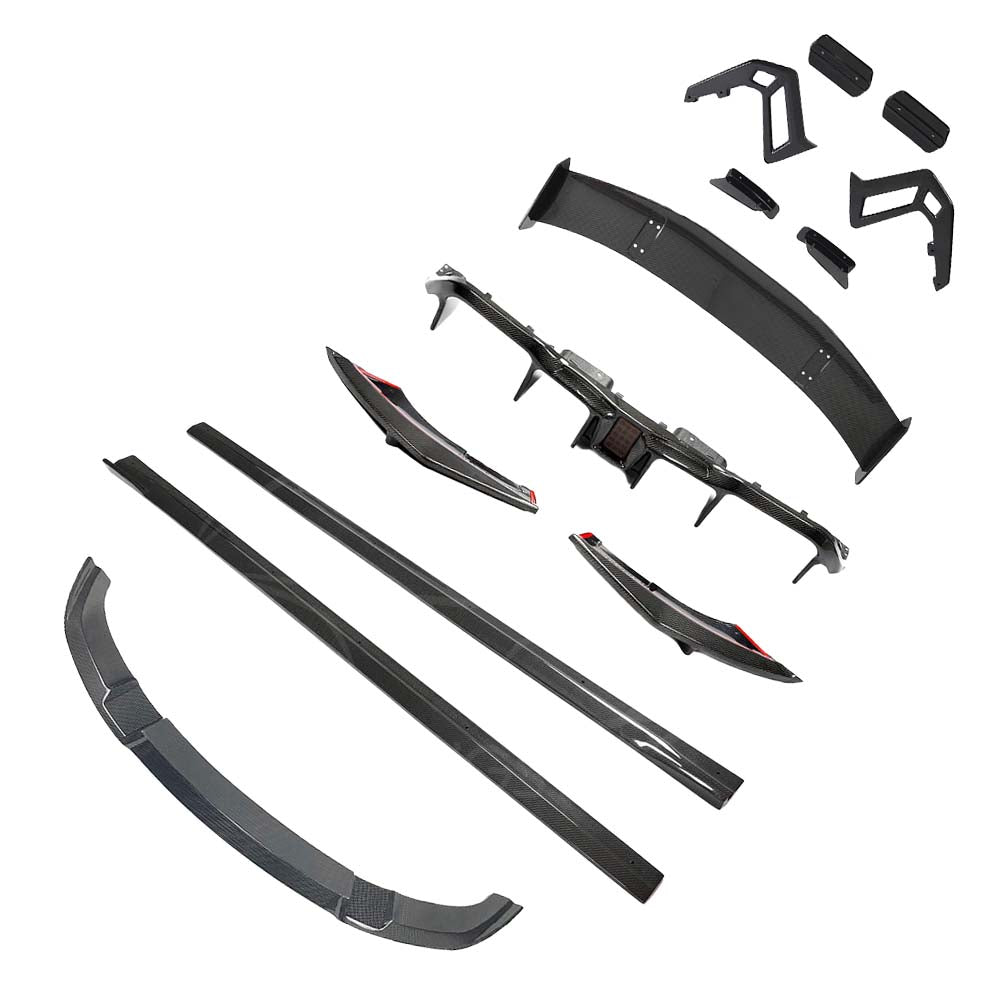 BMW-M2-F87-N55OG-CARBON-FIBRE-SPLITTER-M4-CS-STYLE_edf1ca06-4e5b-4403-b7df-0e05e69e429bjpg - OPSHOLDERS Carbon fiber car body kit pieces laid out, including side skirts, front splitter, rear diffuser, and various aero components.