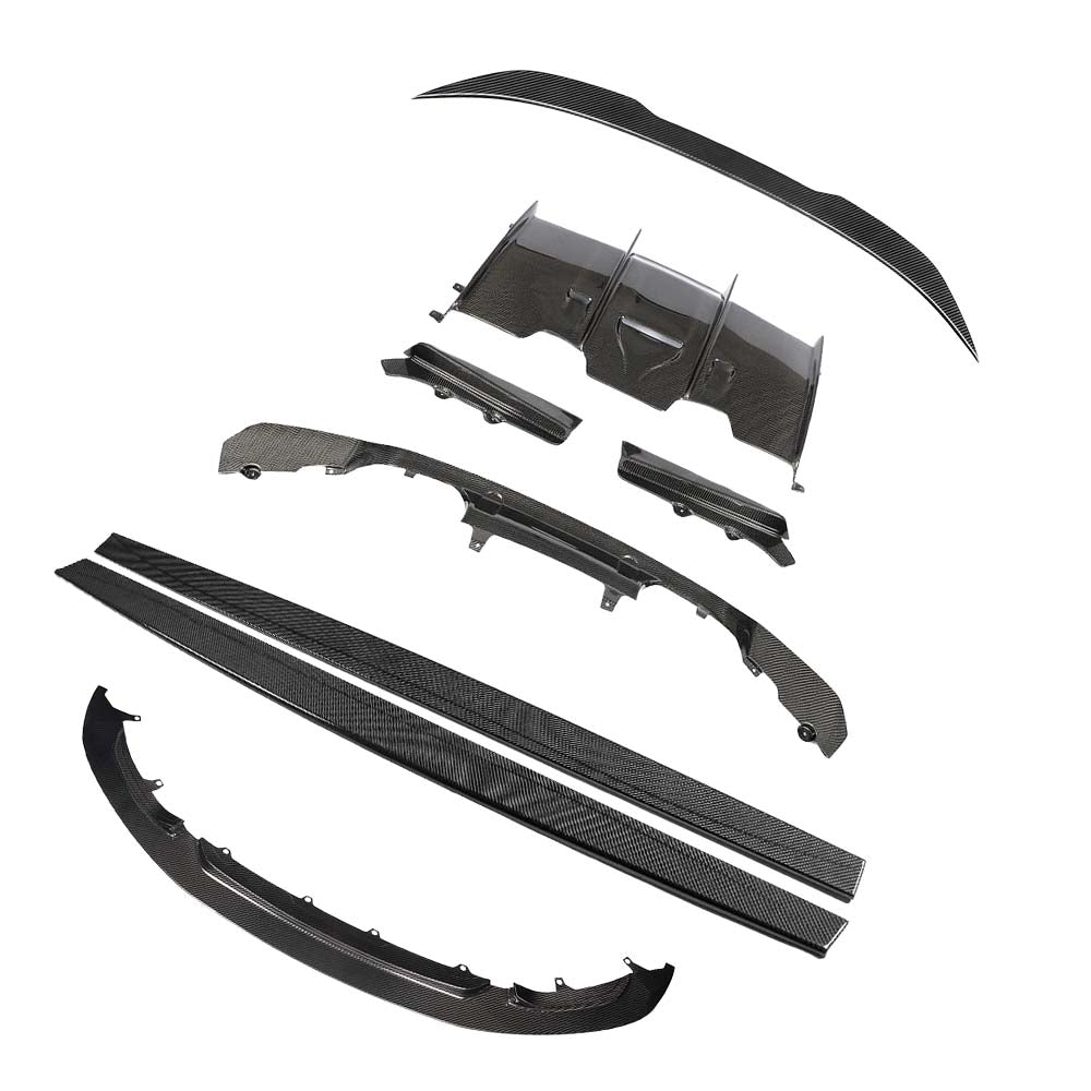 BMW-M3M4-F80-F82-F83-PRE-PREG-CARBON-FIBRE-SPLITTER-GT-STYLE_f546e71d-d3a2-415f-b0ed-499dd7237731jpg - OPSHOLDERS Set of carbon fiber automotive body parts laid out, including front lip, side skirts, bumper components, and rear diffuser.