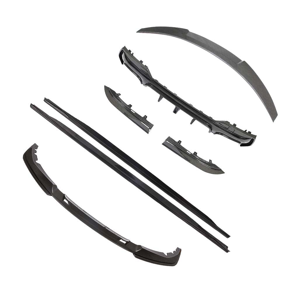 BMW-M44-SERIES-G82G22-PRE-PREG-CARBON-FIBRE-SPOILER-DA-STYLE-2_3c4991b4-619f-4f0e-9a0c-0974bb5b9da1jpg - OPSHOLDERS Assorted black carbon-fiber automotive bumper and side trim parts laid out on a white background.