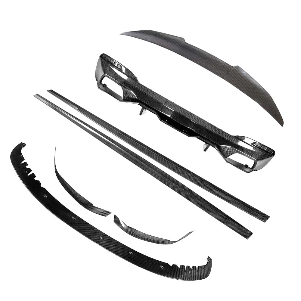 BMW-M5-F90-G30-5-SERIES-CARBON-FIBRE-SPOILER-DUCKTAIL-PS-STYLEjpg - OPSHOLDERS Collection of black carbon-fiber car aero parts laid out: bumper lip, side skirts, and various trim pieces