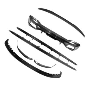 Carbon fiber automotive body kit parts spread out, including front bumper lip and side skirts.