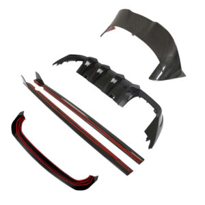 Disassembled carbon fiber car body kit with front splitter, side skirts, rear diffuser, and bumper pieces. Each part is shown separately.