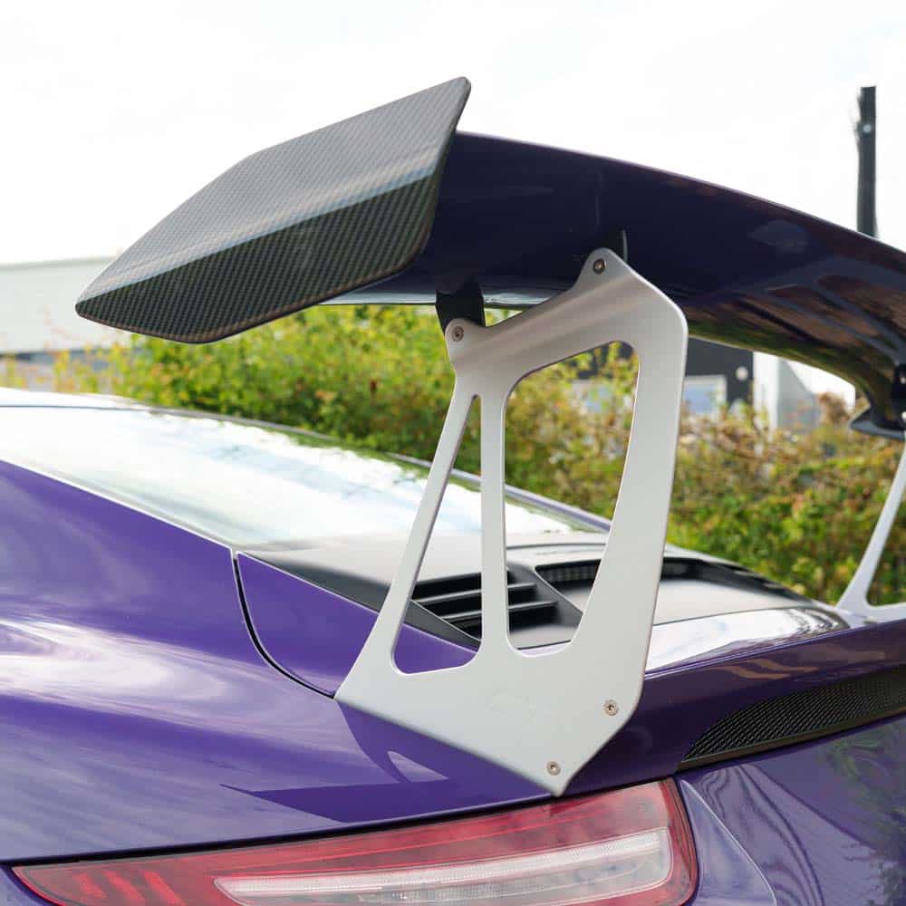 DSC00075jpg - OPSHOLDERS Rear spoiler with carbon fiber endplate mounted on a purple sports car, showing aerodynamic wing support.