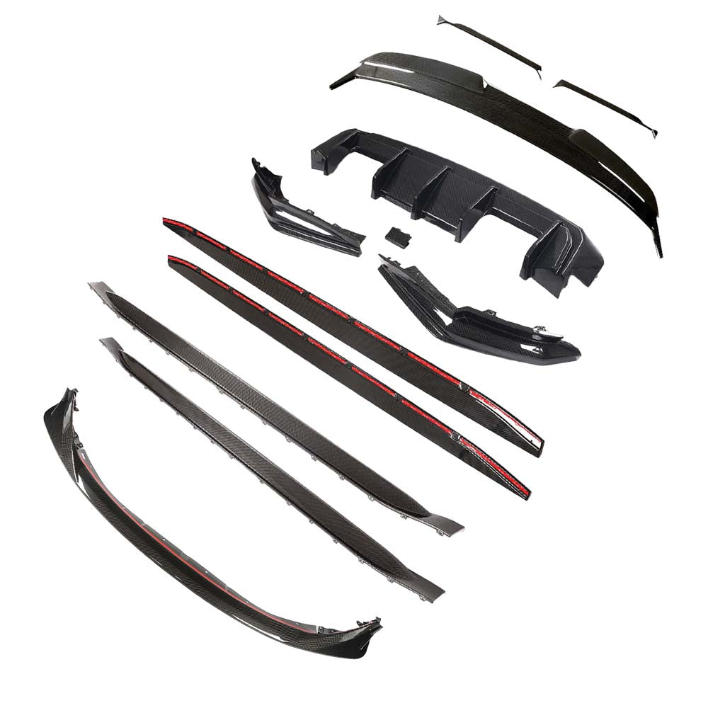 IMG_6577_37e79f3e-1900-49da-9e79-90589bec5f69jpg - OPSHOLDERS Set of carbon fiber car body kit parts (side skirts, spoilers, splitters, and bumper components) laid out on white background.