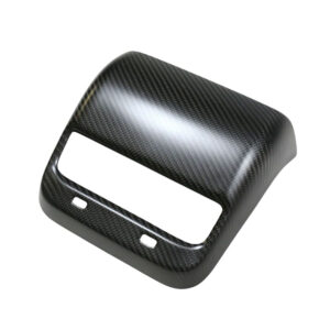 Carbon fiber–style car interior trim panel with a large rectangular opening and two small mounting holes, likely a dash/stereo bezel.