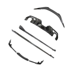Disassembled carbon-fiber car bumper kit parts laid out on white background
