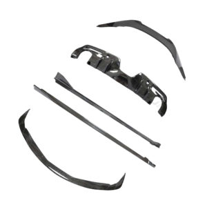 Assorted carbon-fiber car body parts scattered on a white background, including bumper pieces and side skirts.