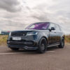 Range_Rover1x1_150725_CTCarbon_26_43e94a25-5cca-47df-a8e5-67a7658a8bbejpg - OPSHOLDERS Black Range Rover SUV parked on a lot, purple-tinted windshield, front grille and CT CARBON plate visible