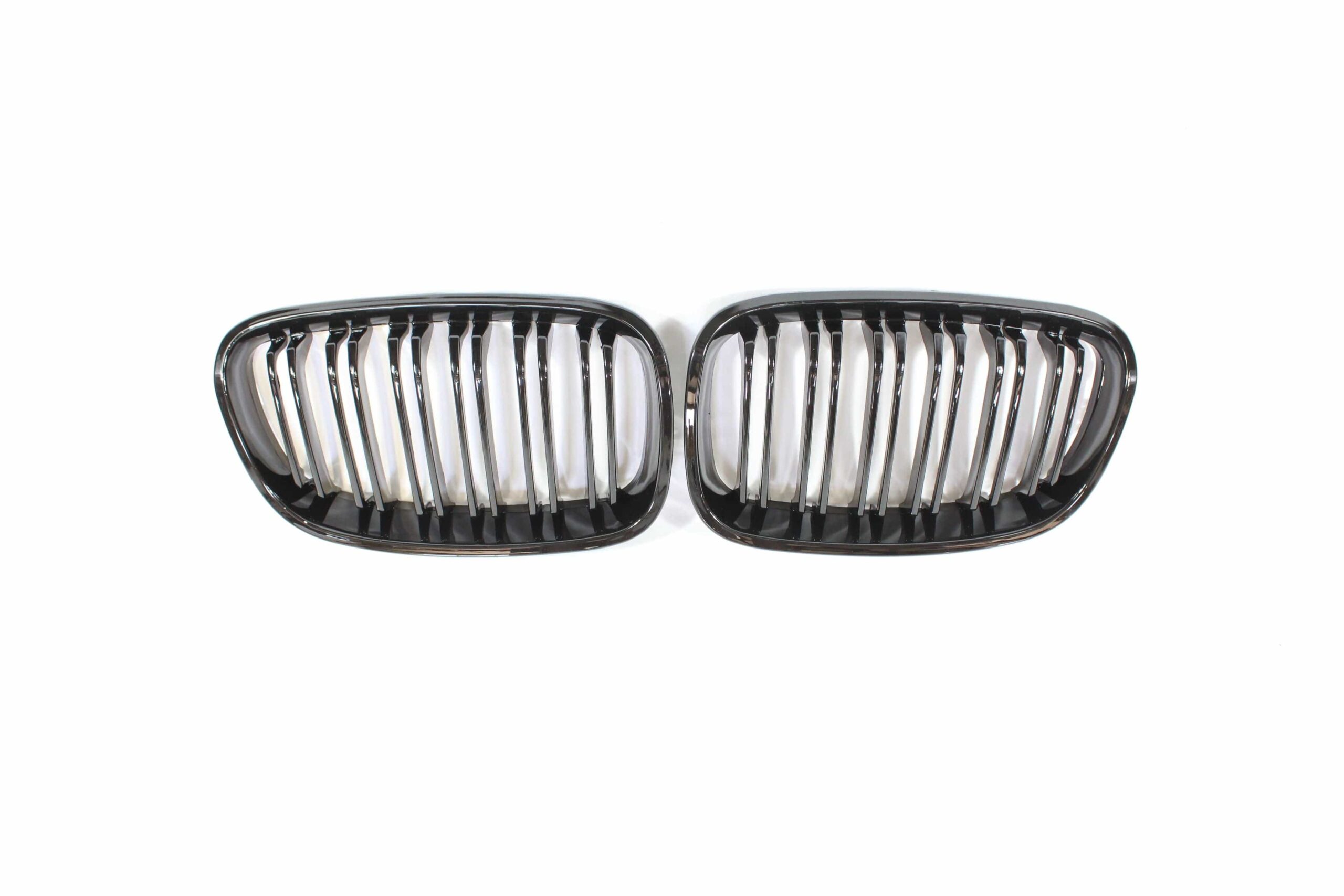 blak-by-ct-grille-bmw-f20-1-series-pre-lci-double-slat-black-grilles-blak-by-ct-carbon-ct-carbon-bmw-f20-1-series-pre-lci-double-slat-black-grills-28580363010218jpg - OPSHOLDERS Two black automotive grilles with vertical chrome slats placed side by side on a white background