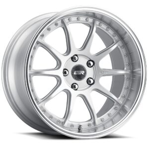 Silver alloy wheel with a multi-spoke design and polished lip, center cap visible with logo nuts around the hub.