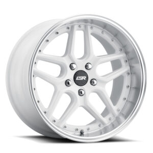White multi-spoke alloy car wheel with a polished lip and center cap
