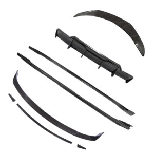 Assorted black carbon fiber car aero parts (spoiler, diffusers, and side skirts) arranged on a white background.