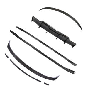 Disassembled black car spoiler kit with multiple curved aero trims laid out on white background