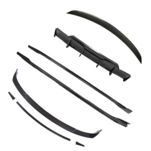Carbon fiber car aero kit parts scattered, including front splitter, side skirts, and rear spoiler.