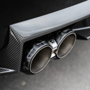 Akrapovic BMW M2 CS (G87) Slip-On Line S-BM/T/39H - OPSHOLDERS Dual exhaust tips with a carbon-fiber rear bumper on a sports car.