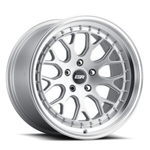 Silver multi-spoke alloy wheel with a riveted outer lip and center cap bearing 'BSR' logo