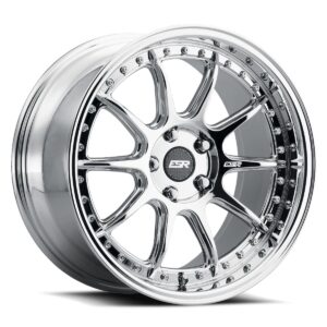 Polished chrome alloy wheel with a multi-spoke design and rivet-lined lip, center cap visible.