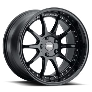 Glossy black alloy wheel with ten spokes, chrome rivets around the edge, and a central cap.