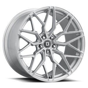 Silver alloy wheel with a complex, angular multi-spoke design and a central cap bearing a 'B' logo