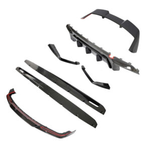 Exploded view of a carbon fiber car body kit including front splitter, side skirts, rear diffuser, and spoiler pieces laid apart.