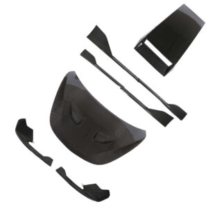 Carbon fiber automotive aero kit parts laid out, including a large curved front piece, end plates, and smaller wing components (splitter, diffusers).