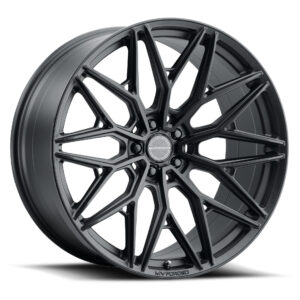 Close-up of a black multi-spoke alloy wheel with MV Forged center cap at the hub area.