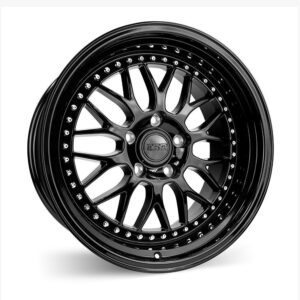 Close-up of a glossy black alloy car wheel with a vented spoke design and rivet-lined outer rim.
