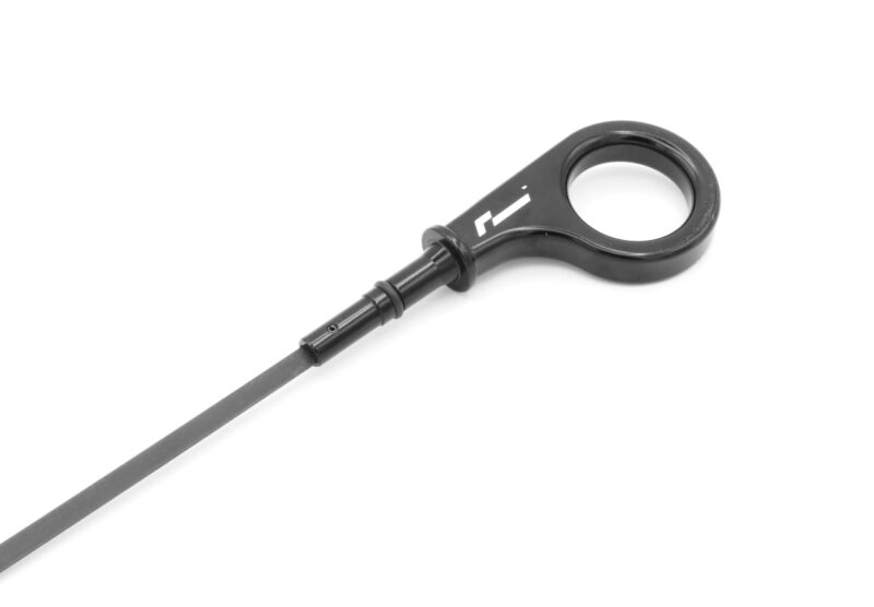 10-14-tsi-billet-dipstick_53400129825_o-scaled-1jpg - OPSHOLDERS Close-up of a black tool with a circular ring at the end and a straight shaft, set against a white background, diagonal orientation.