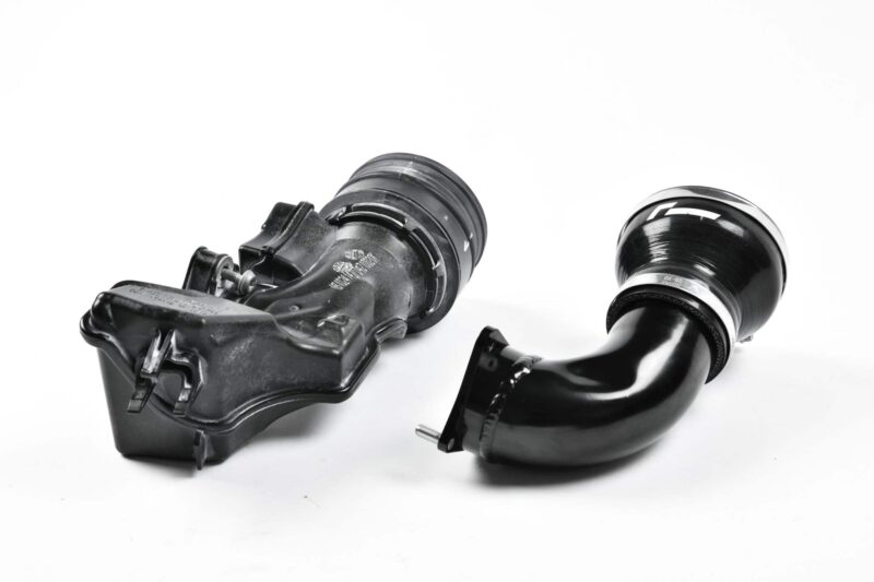 Disassembled turbocharger parts on a white background: compressor and turbine housings visible on black metal components
