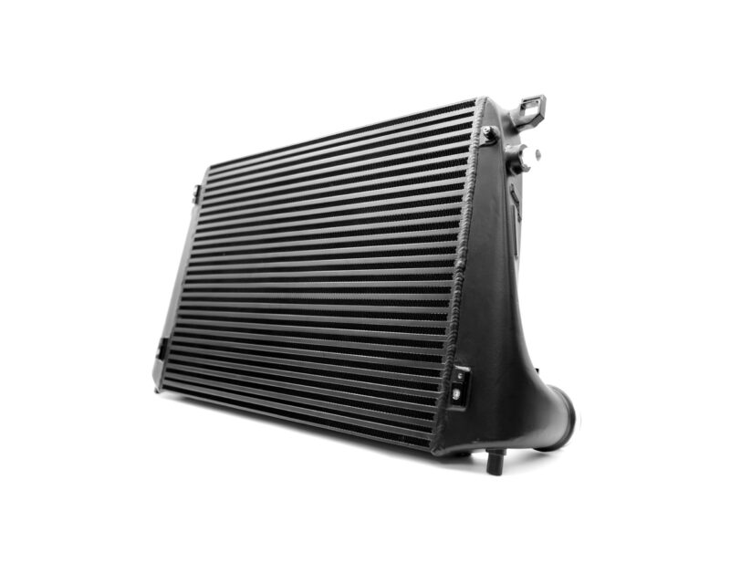 Angled close-up of a vehicle radiator with ribbed core and side tanks, showing mounting brackets and fittings on the right edge.