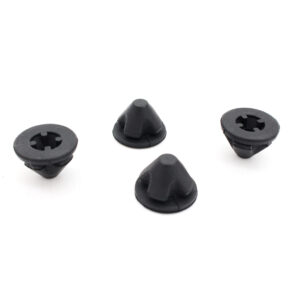 Close-up of several small black plastic fasteners with circular washer-like bases on a white background.