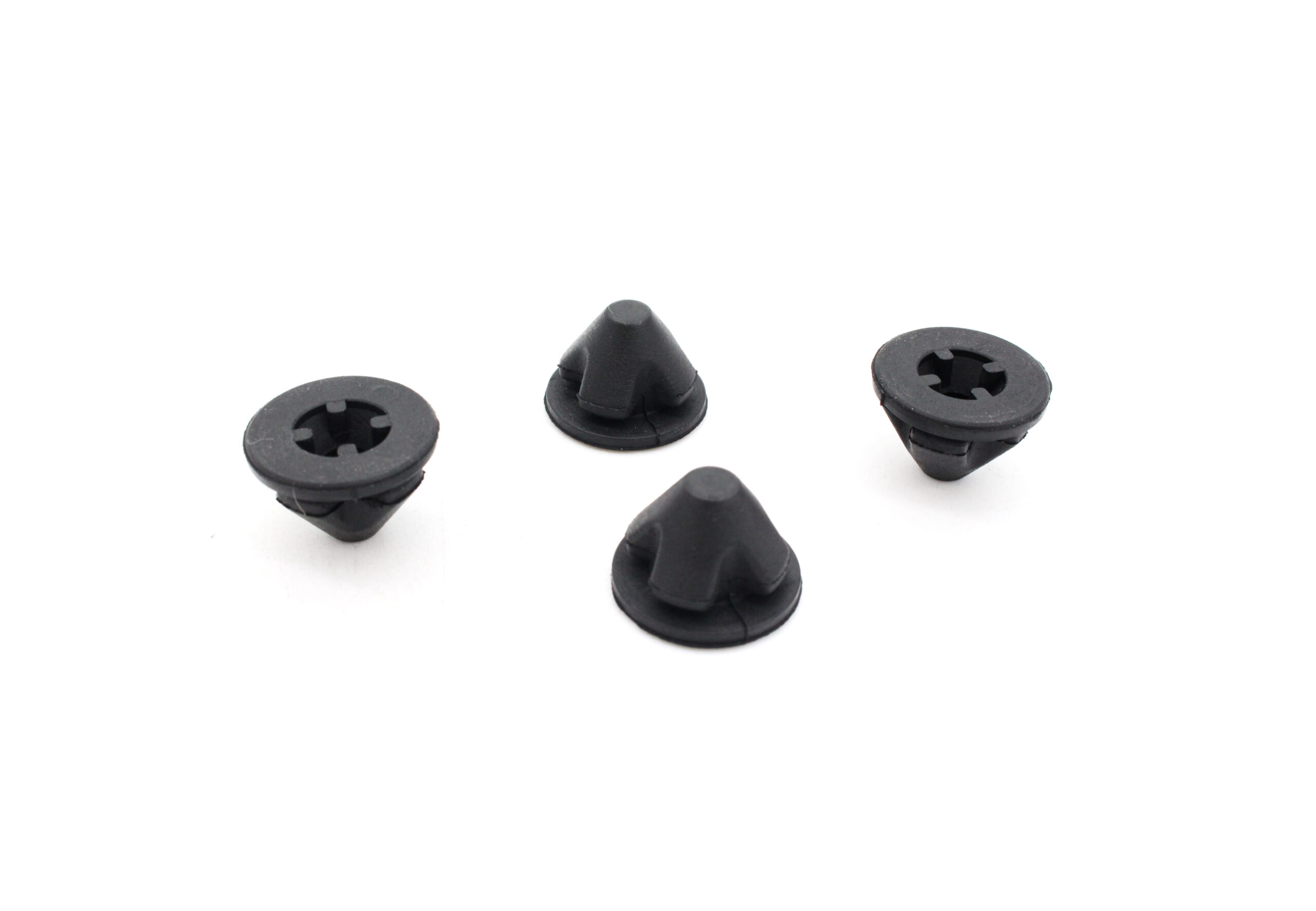 25-tfsi-engine-cover-grommets_53351684577_o-scaled-1jpg - OPSHOLDERS Close-up of several small black plastic fasteners with circular washer-like bases on a white background.
