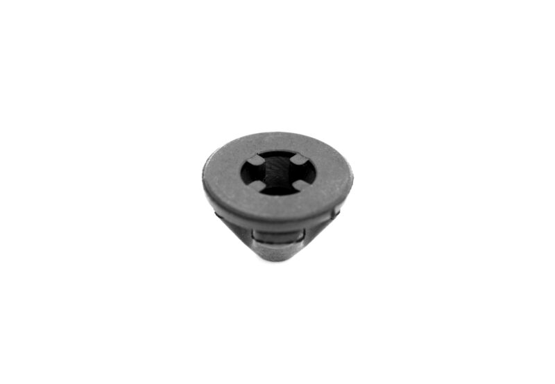 25-tfsi-engine-cover-grommets_53351684587_o-scaled-1jpg - OPSHOLDERS Close-up of a black circular plastic piece with four internal tabs at its center (macro shot).