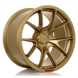 Gold-colored alloy wheel with a multi-spoke design and center cap, shown at an angle for product viewing