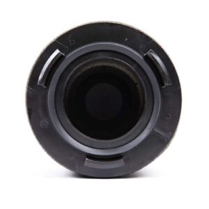 3-73-1jpg - OPSHOLDERS Close-up view of a camera lens opening facing the viewer, showing the circular mount and dark interior.