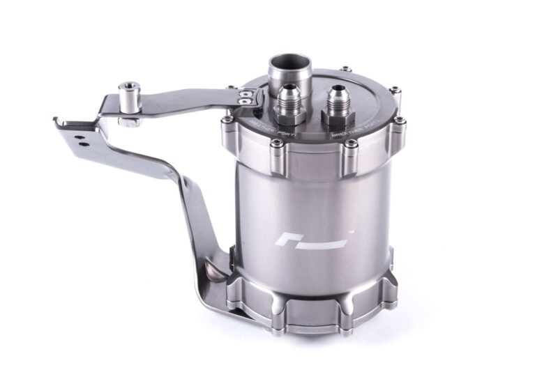 Close-up of a stainless steel valve/regulator with multiple ports and a long lever handle attached to a cylindrical body.