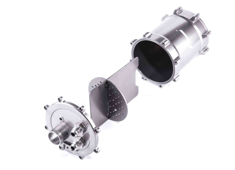 Metallic industrial valve body with circular flange and bolted ring, viewed at an angle to show its opening and fasteners