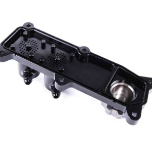 Black plastic enclosure with multiple posts and a perforated base, shown at an angle against a white background, likely a housing component for electronics or automotive systems.