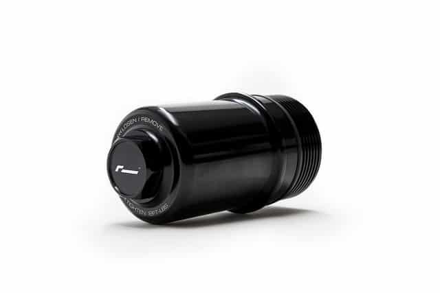 37361772860_0ef35e20d0_z__412361517223948-1jpg - OPSHOLDERS Close-up of a black, threaded cylindrical cap/adapter on a white background.