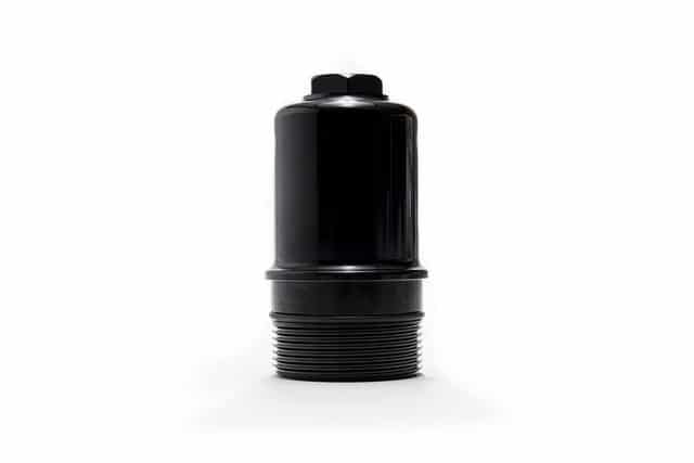 37361774970_2f78d1002b_z__764261517223948-1jpg - OPSHOLDERS Black plastic cylindrical object with a threaded base sits on a white background.