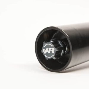 50587030466_1b428d6a3c_c-1jpg - OPSHOLDERS Close-up of a black cylindrical tube with a circular end cap featuring the JR logo.