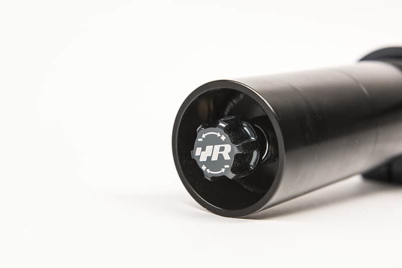 50587030466_1b428d6a3c_c-1jpg - OPSHOLDERS Close-up of a black cylindrical tube with a circular end cap featuring the JR logo.