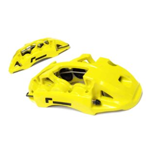 Bright yellow cycling helmet shells with vents on a white background.