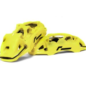 Two bright yellow bicycle helmets with black chin straps, stacked together on a white background.