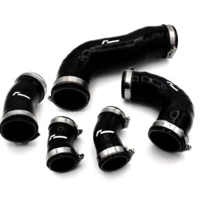 Black silicone automotive hoses with metal clamps scattered on a white surface.